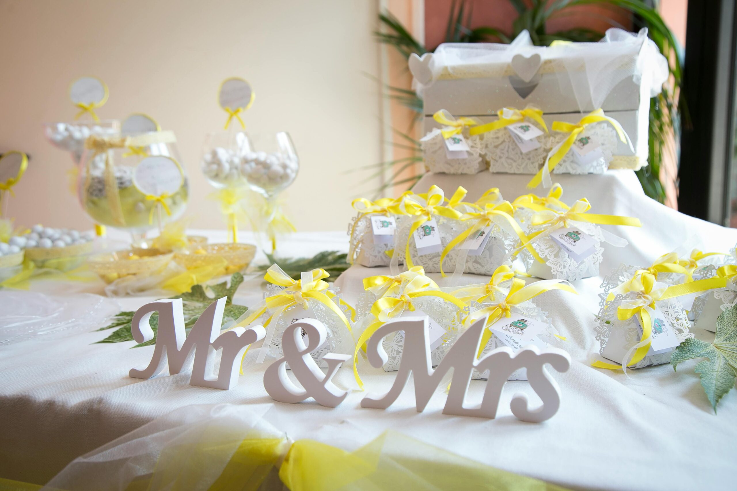 Beautifully decorated wedding table with gifts and Mr & Mrs sign in bright colors.